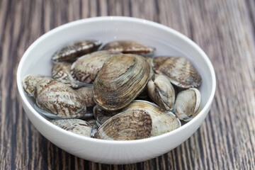 Fresh raw Surf clam on a wooden background.