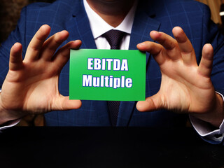 Conceptual photo about EBITDA Multiple with written phrase green business card.