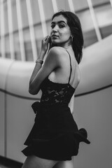 woman in dress posing in black and white