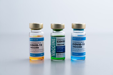 ampoules or vials with Covid-19 vaccine on a laboratory bench. SARS-CoV-2 Vaccination, immunization, treatment to cure Covid 19 Corona Virus infection. Medical concept.