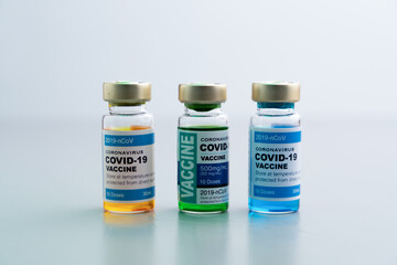 ampoules or vials with Covid-19 vaccine on a laboratory bench. SARS-CoV-2 Vaccination, immunization, treatment to cure Covid 19 Corona Virus infection. Medical concept.