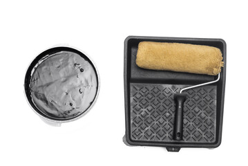 Paint roller, cuvette and jar with a black paint isolated on the white background.