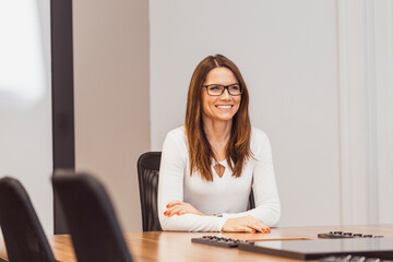 Smiling woman sitting at desk. Happy business people in the office. Smile