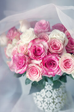 Bright bouquet of a beautiful tea roses in a ceramic jug.Soft focus