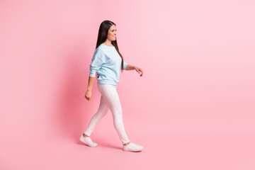 Fototapeta na wymiar Full length body size photo of brunette woman going fast wearing casual clothes isolated on pastel pink color background