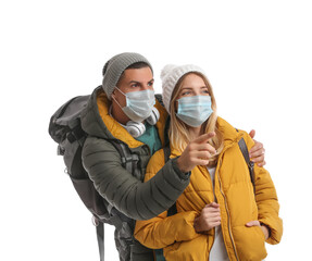 Fototapeta na wymiar Couple in face masks and warm clothes on white background. Winter travel