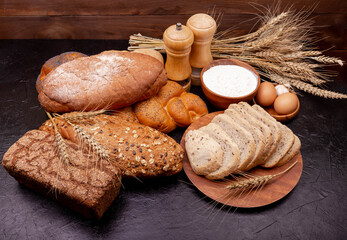 Healthy bread assortment. Bakery products. Various bread rolls. Collection of grain bread and baked goods on wooden background. Shopping food supermarket concept. Bread made from wheat and rye flour.