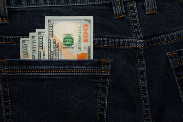 money in your pocket. dollar bills in the back pocket of my jeans. The concept of pocket money. Cash. American money, denominations 100. business, trade or financial transactions. close-up