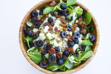 Quinoa, lettuce, lambs lettuce, black olives and cucumber salad