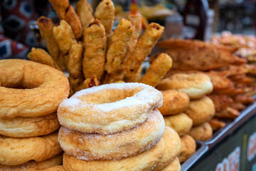 Fresh bakery for sell on market stall. Sugar donuts, cakes and pastries choice. Homemade bakery perspective view