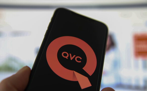 Viersen, Germany - February 9. 2021: Closeup of smartphone screen with logo lettering of QVC , blurred website background