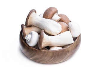 Set of fresh mushrooms in wooden bowl isolated on white