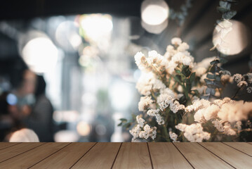 The surface on the empty wooden table and the blur background of the kitchen in the cafe. Can be used as a background for presenting products.