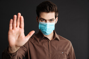 Close up of a confident young man in medical protective mask