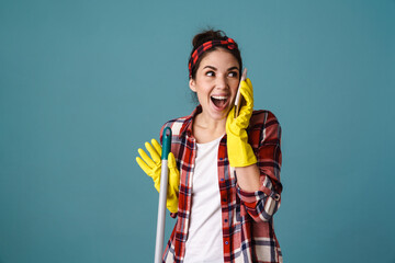 Excited attractive woman in rubber gloves and apron