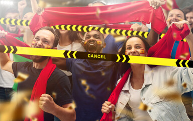 Obraz premium Lockdown. Spainian soccer, football fans cheering for favourite sport team with bright emotions behind the limiting tapes with Cancel. Look excited, supporting, wondered. Blocked social life.