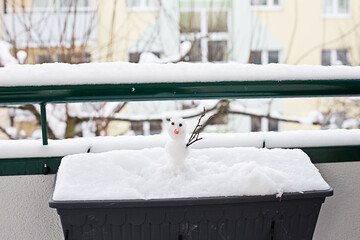 small, fun  snowman in wintertime