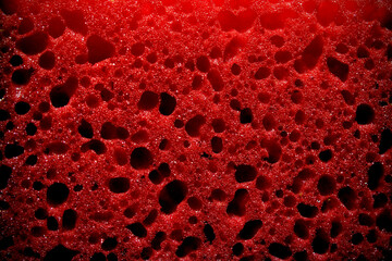 Close up image of a red sponge. Red sponge background