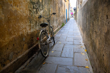 Rustic bicycle on narrow street, asian cityscape. Traditional personal transport in Asia. Vietnam city culture.
