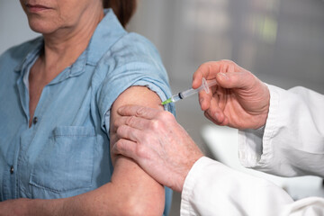 Doctor giving vaccin injection to patient