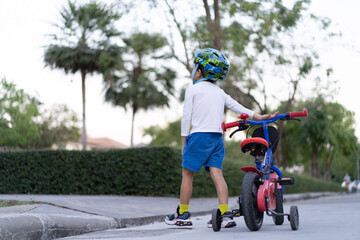 boy is riding bicycle at the park.