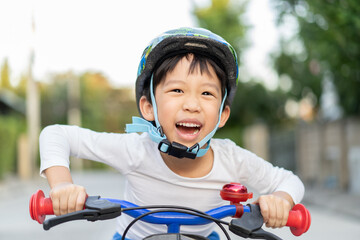 boy is riding bicycle at the park.