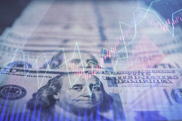 Double exposure of forex graph drawing over us dollars bill background. Concept of financial...