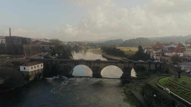 An aerial view of cars passing through the medieval bridge at Barcelos, Portugal in 4K