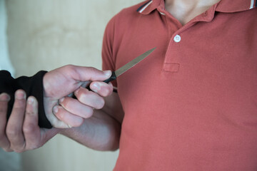thief holding knife with man