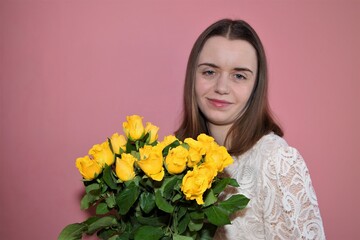 Portrait of a woman with yellow Easter roses.