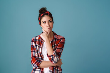 Puzzled beautiful brunette girl posing and looking aside