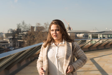 Fototapeta premium Woman in winter jacket and white shirt with hand on jacket