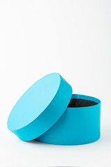 View of open blue round cardboard box, on white background, vertically, with copy space