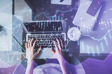 Double exposure of woman hands working on computer and forex chart hologram drawing. Top View. Financial analysis concept.
