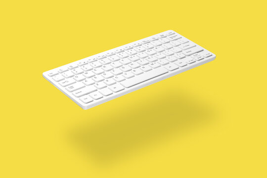 . White computer keyboard levitating on yellow background, shadow visible. The concept of modern digital technologies, online work, training, sales, etc.
