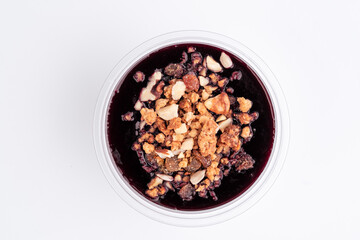 chia pudding with blueberries in plastic container on green background. Top view. Close up. Photo for clipping, for the menu