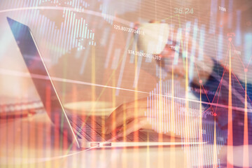 Double exposure of businesswoman hands typing on computer and forex graph hologram drawing. Financial analysis concept.