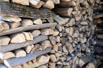 A large woodpile of wood was collected in the village to heat the house in winter.