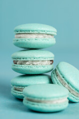 Blue handmade macarons on a blue  background