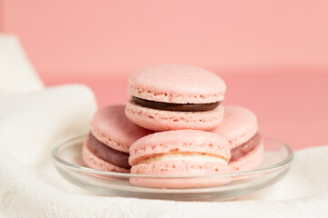 Pink homemade macarons on a pink background