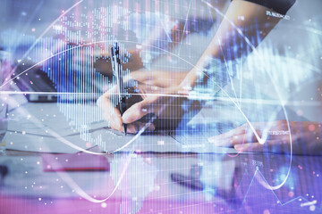 Double exposure of woman hands typing on computer and business theme hologram drawing. Success...