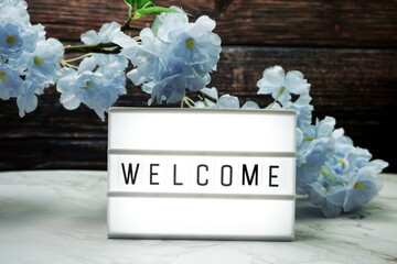 Welcome word in light box with Flowers Decoration