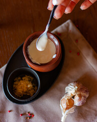 
white sauce with garlic in a clay pot