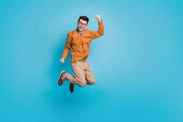 Fototapeta na wymiar Full body photo of young excited man happy celebrate win victory success fists hands isolated over blue color background