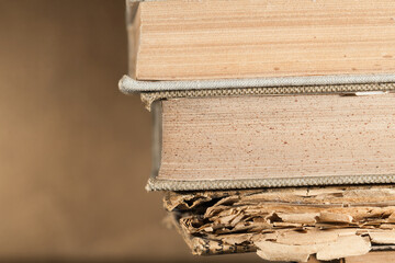 Stack of books on unfocused background, arrangements.
