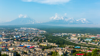 Fototapeta na wymiar View of the city Petropavlovsk-Kamchatsky on background of Avachinsky, Koryaksky and Kozelsky Volcanoes. Russian Far East, Kamchatka Peninsula.