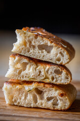 A beautiful traditional focaccia cut into pieces. Focaccia of natural sourdough