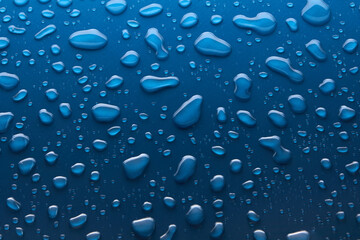Moisturizing liquid blue drops on pastel background. Cosmetic toner or Water Drops. Hyaluronic serum Bubbles close-up.