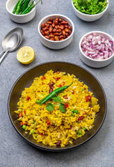 spicy Indian snack or breakfast  poha with onion and peanuts