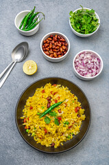 spicy Indian snack or breakfast  poha with onion and peanuts